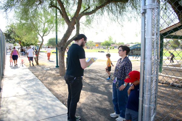 A teacher talks to one of his students in the courtyard